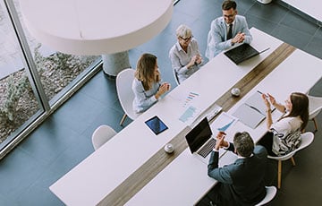 Aerial perspective of business people sitting at conference table